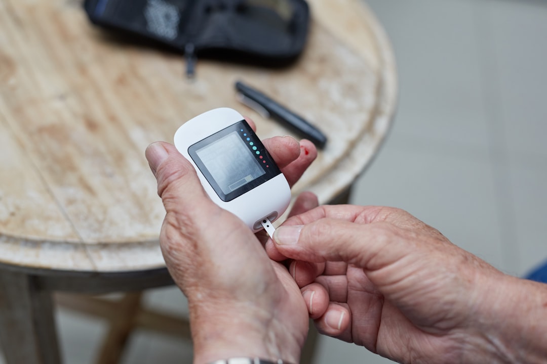 Man testing blood sugar ( glucose) for Type 1 or Type 2 using a gluco-meter.
